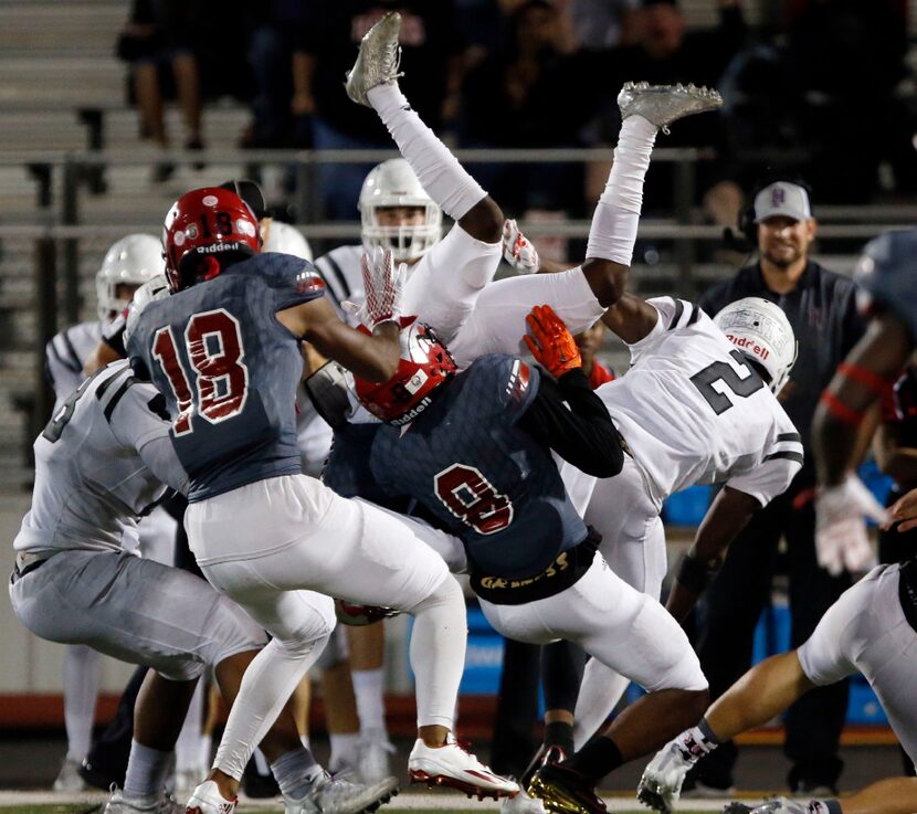 Mesquite Horn High's Breon Emerson (legs in air) goes high to recover a Rockwall-Heath High...