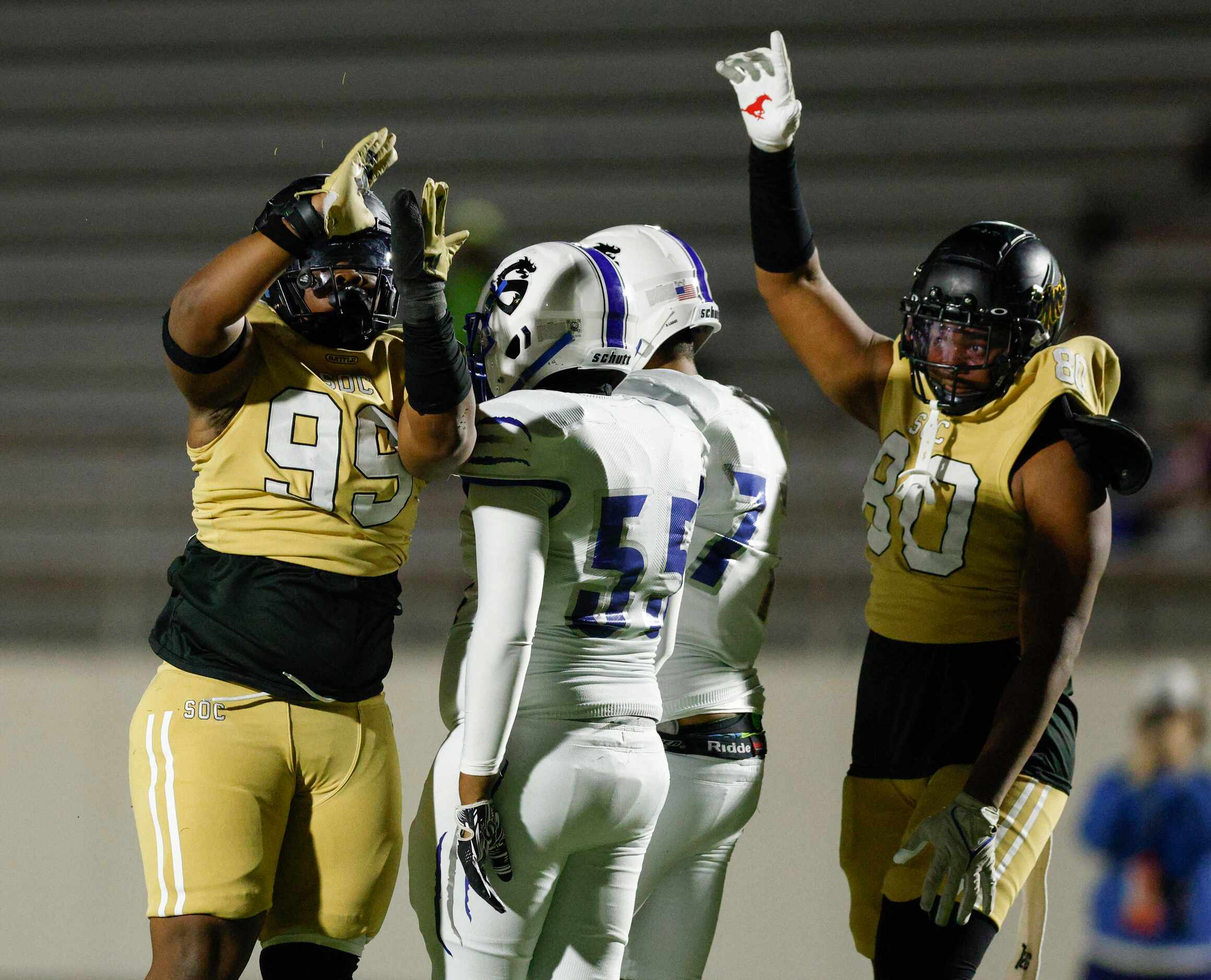 South Oak Cliff defensive linemen Courtland Kidd (99) and Keith Smith (80) celebrate after a...