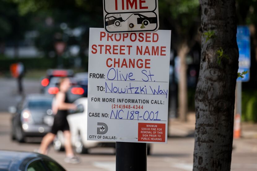 A sign at Olive Street and North Houston Street gives notice of a proposed renaming of Olive...