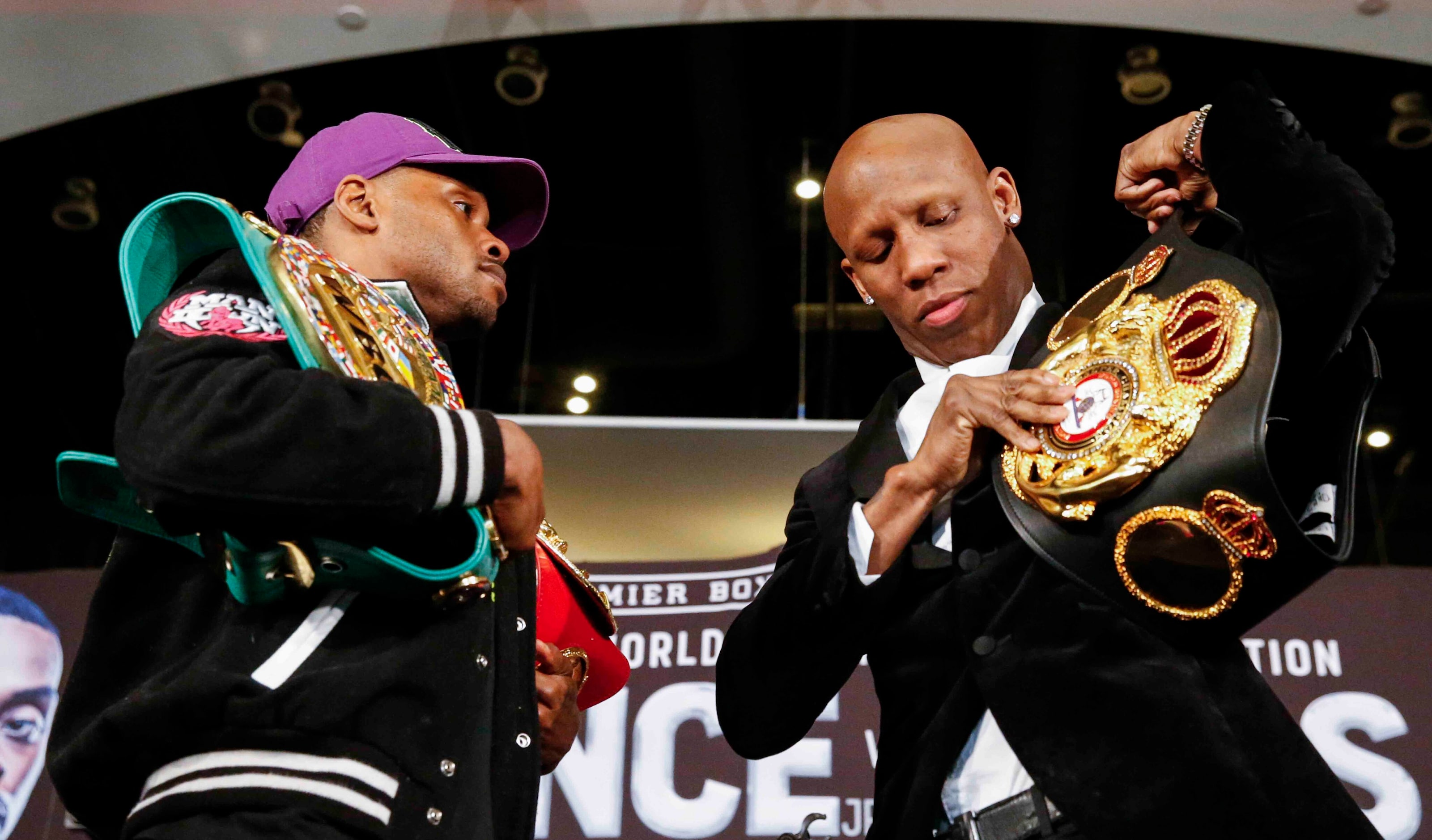 Errol Spence Jr., left, looks towards Yordenis Ugas as he prepares his belt for a staredown...