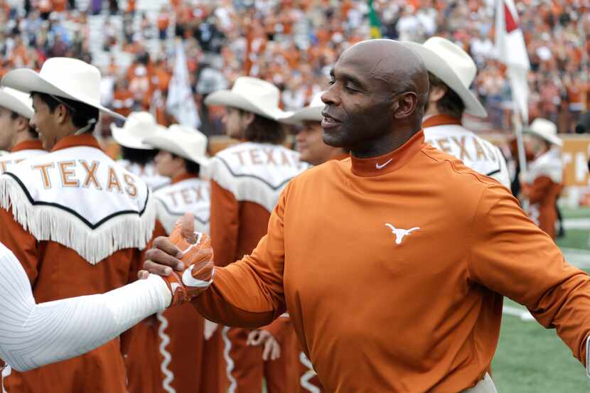 Texas head coach Charlie Strong greets his senior players before an NCAA college football...