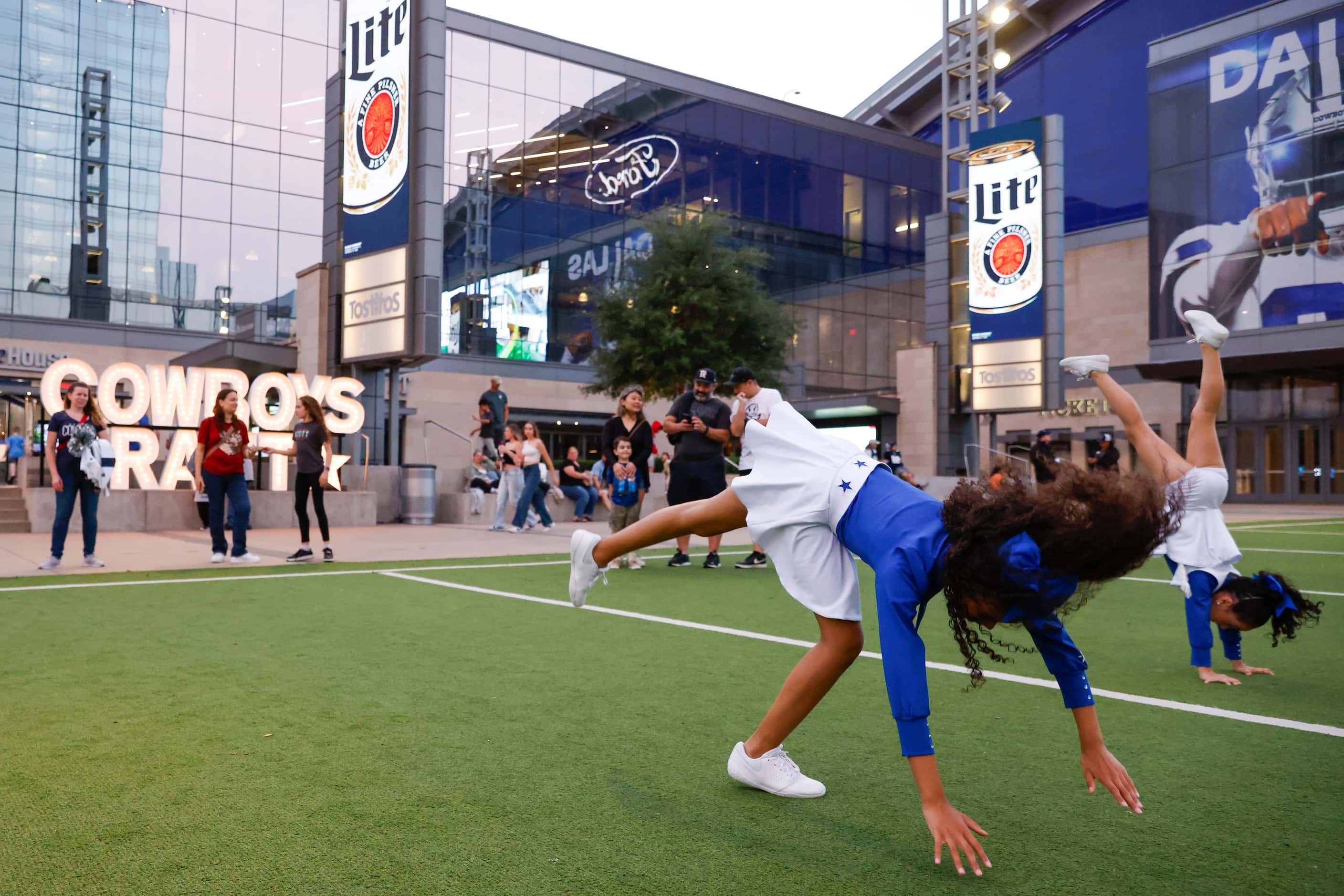 Junior Dallas Cowboy Cheerleaders play around the turf in the second round of the NFL Draft...