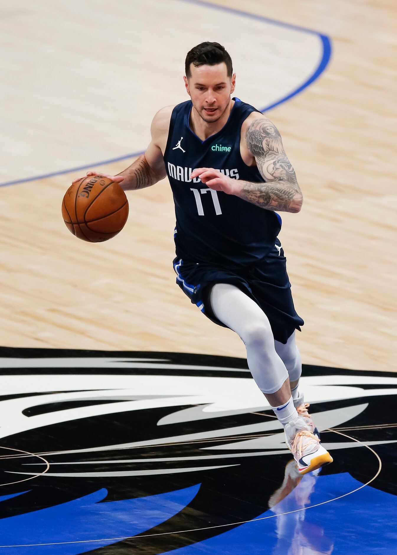 Dallas Mavericks guard JJ Redick (17) drives up the court during the first half of an NBA...