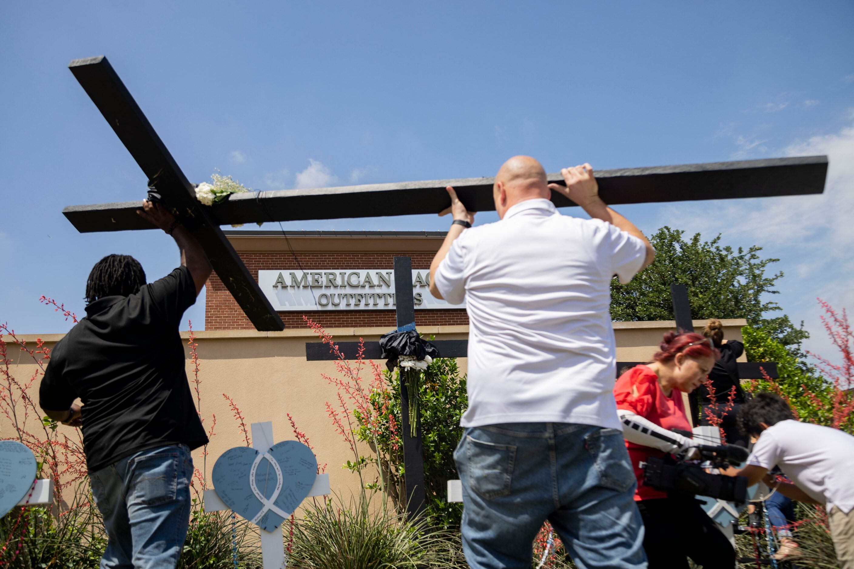 Black crosses are erected at a memorial outside the mall after a mass shooting at Allen...