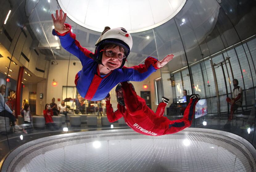 Ian Hook-Adams, 11, learns how to indoor sky dive with the assistance of instructor Dave...
