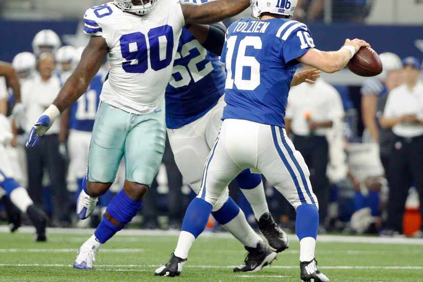 Dallas Cowboys defensive end Demarcus Lawrence (90) pressures Indianapolis Colts quarterback...