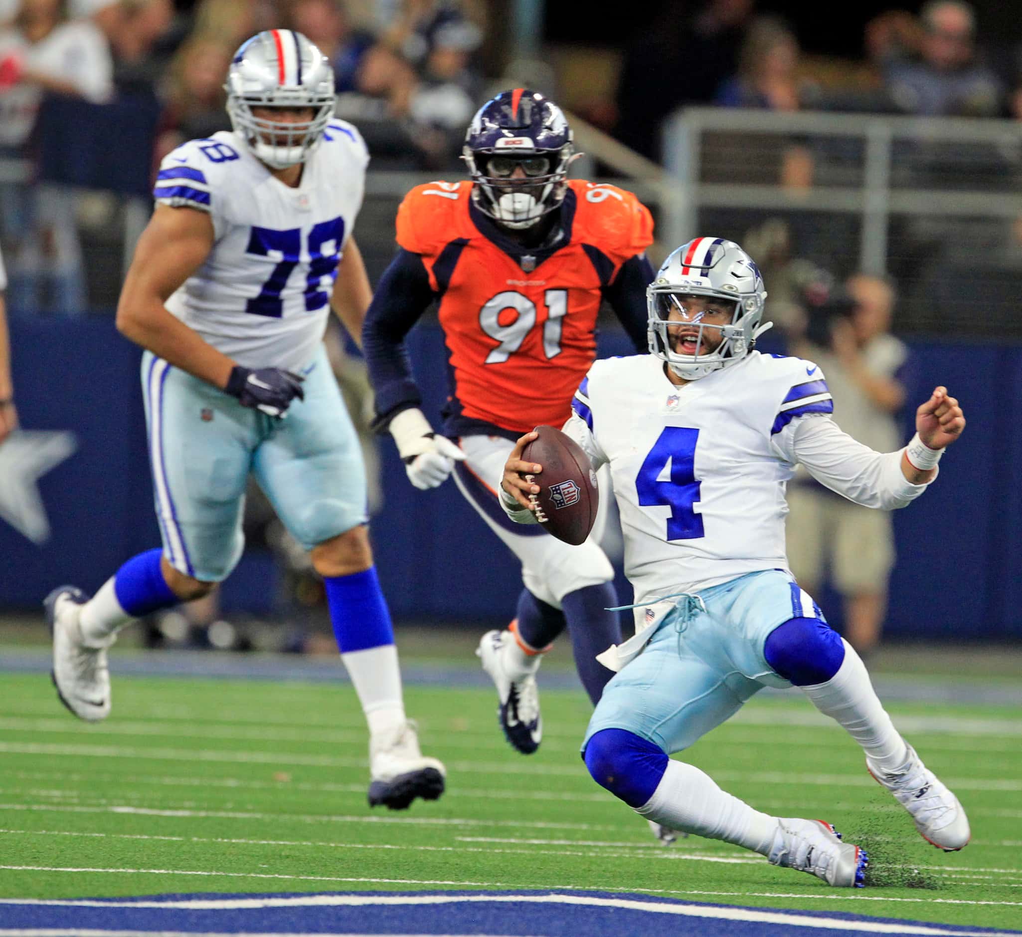 Dallas Cowboys quarterback Dak Prescott (4) slides after scrambling for a gain during the...