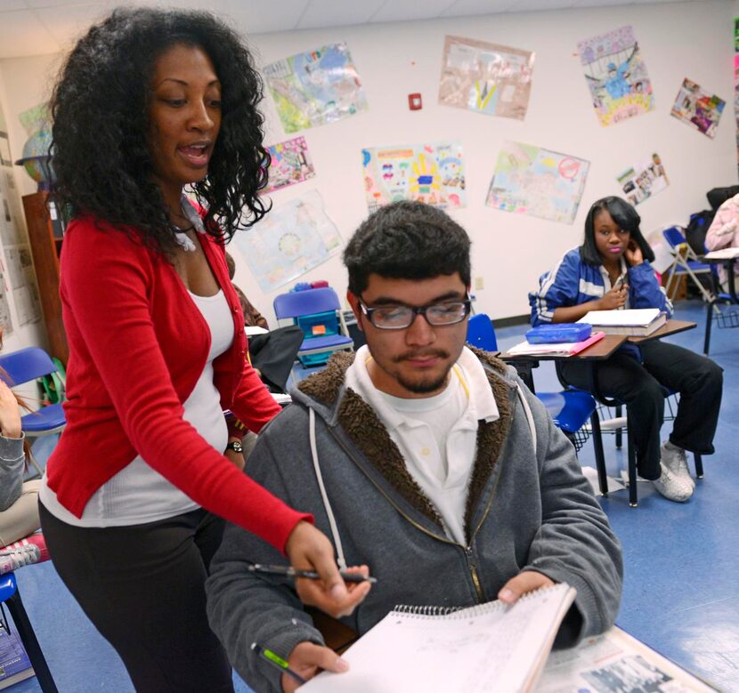 
Dallas Can Academy social studies teacher Danyelle Williams helps Nelson Sanchez with his...