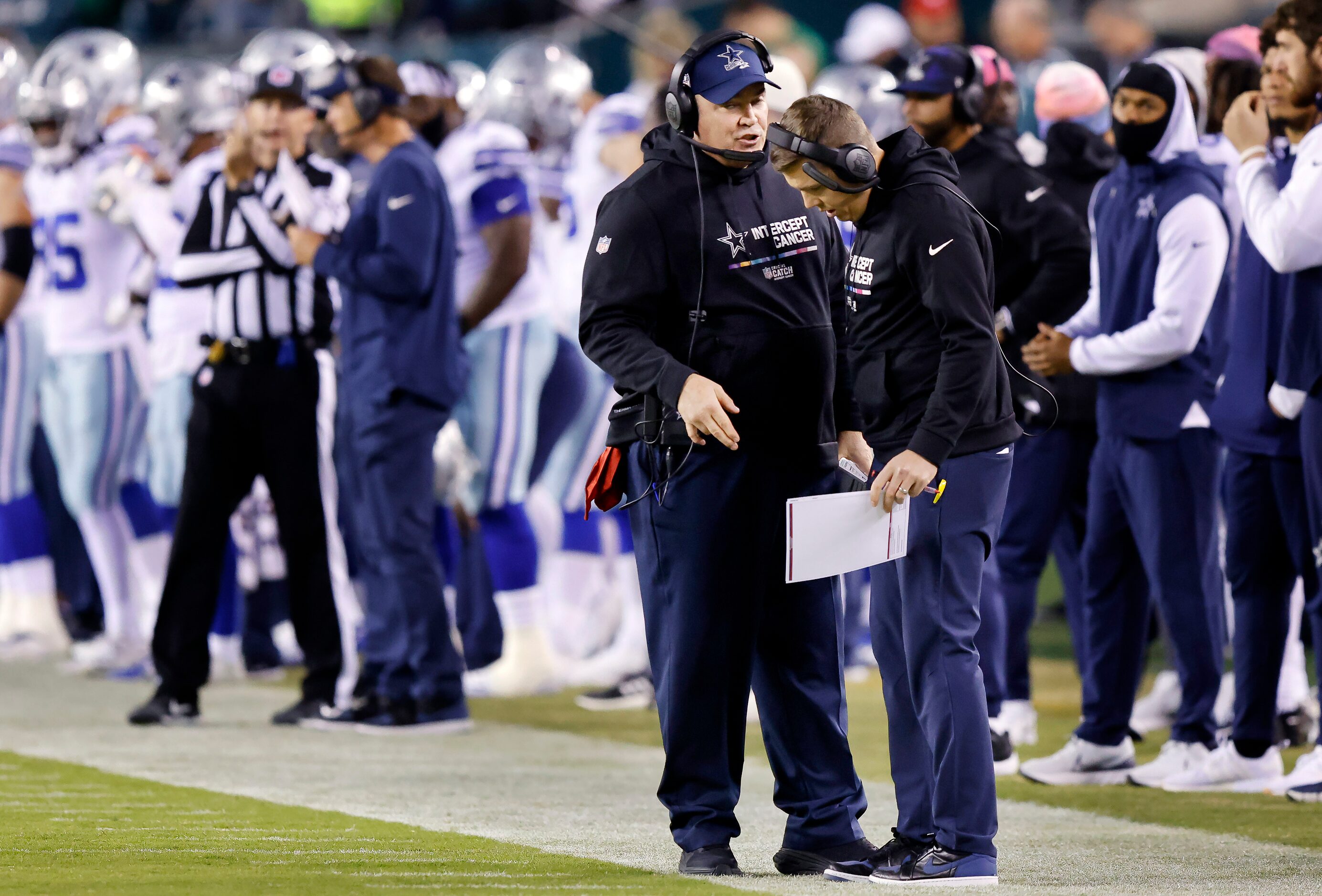 Dallas Cowboys offensive coordinator Kellen Moore listens to head coach Mike McCarthy after...