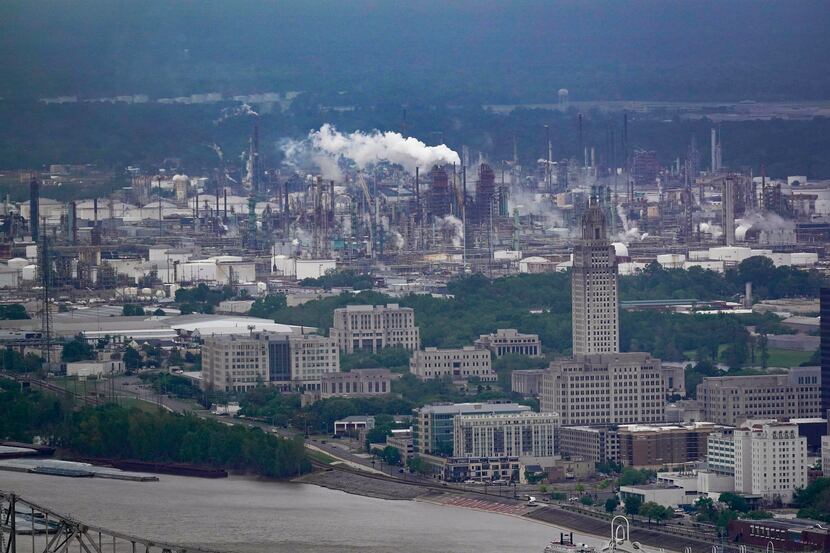 The Exxon Mobil Baton Rouge Refinery complex is visible with the Louisiana State Capitol,...