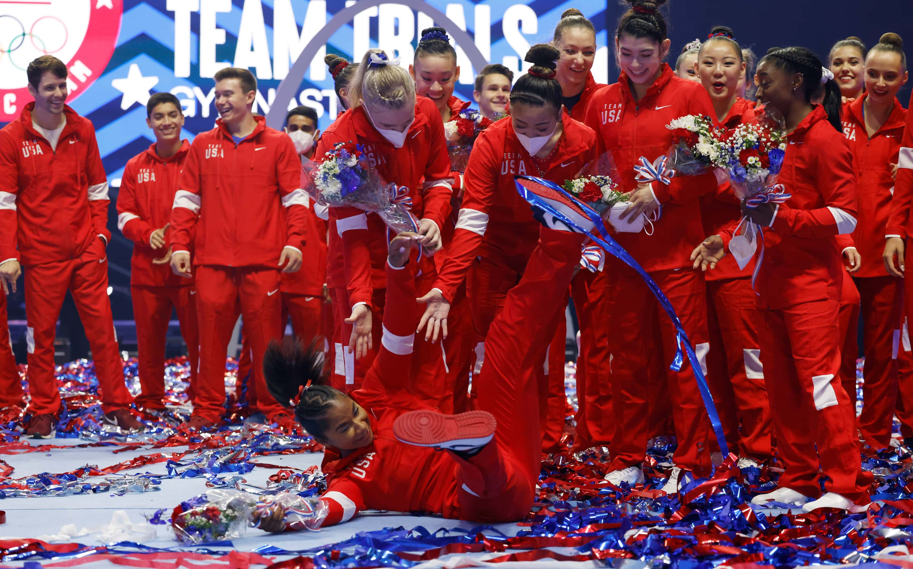 Jordan Chiles falls rushing to get into a group photo after the women's U.S. Olympic...