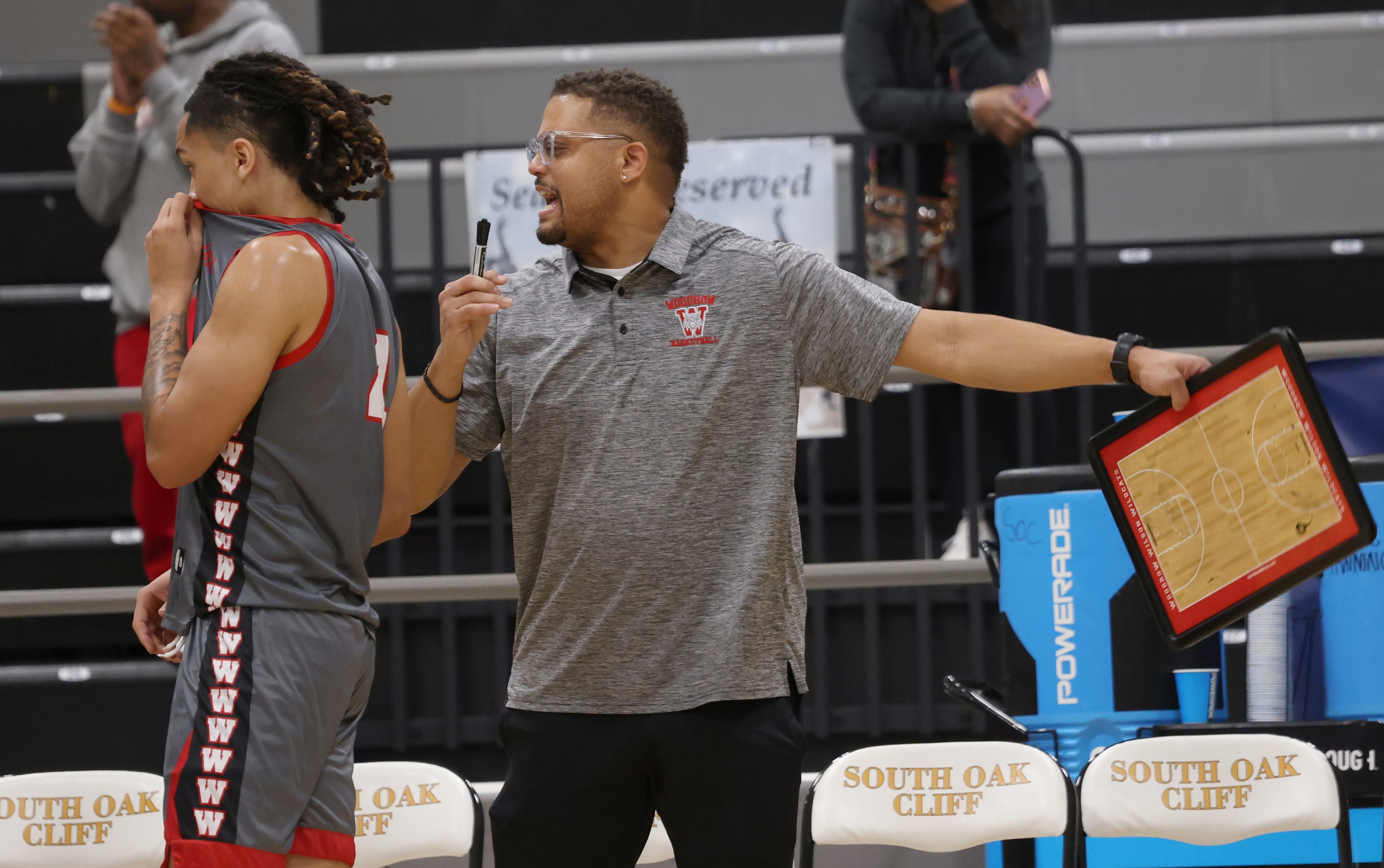 Dallas Woodrow Wilson head coach Billy Cunningham works to round up his players for a...