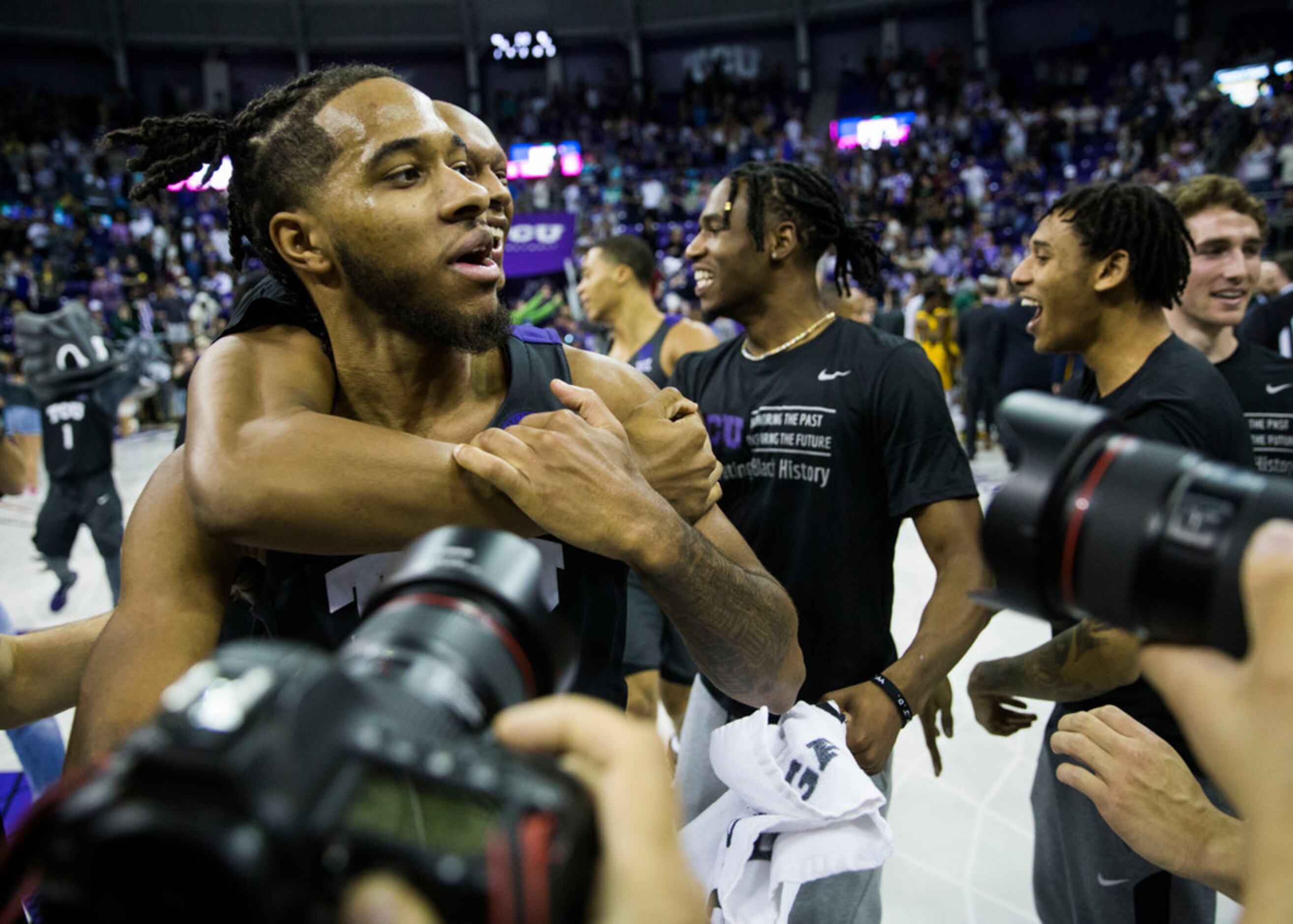 TCU Horned Frogs guard PJ Fuller (4) celebrates after fans rush the court because of a 75-72...
