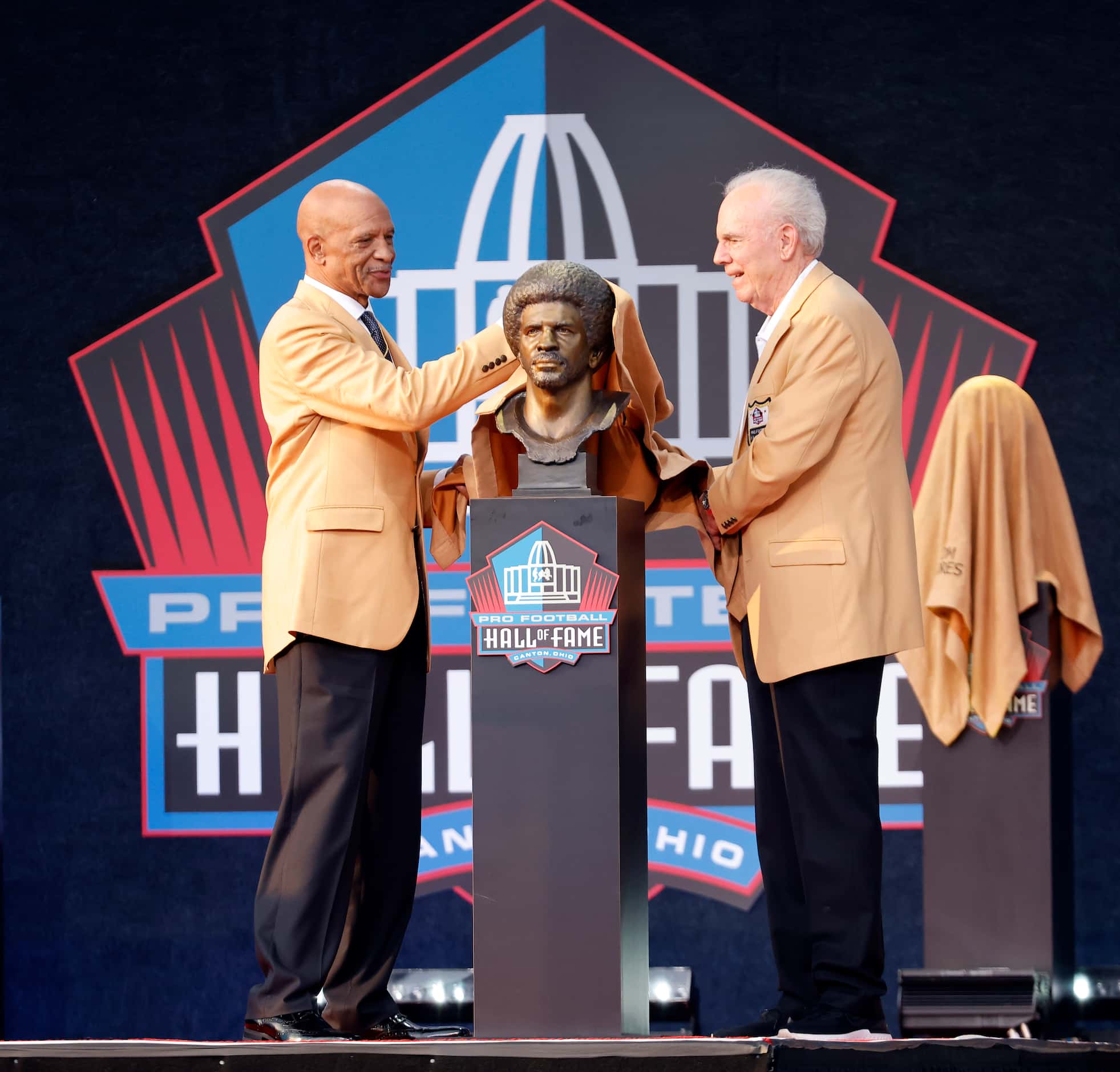 Pro Football Hall of Fame inductee Drew Pearson of the Dallas Cowboys (left) unveils his...