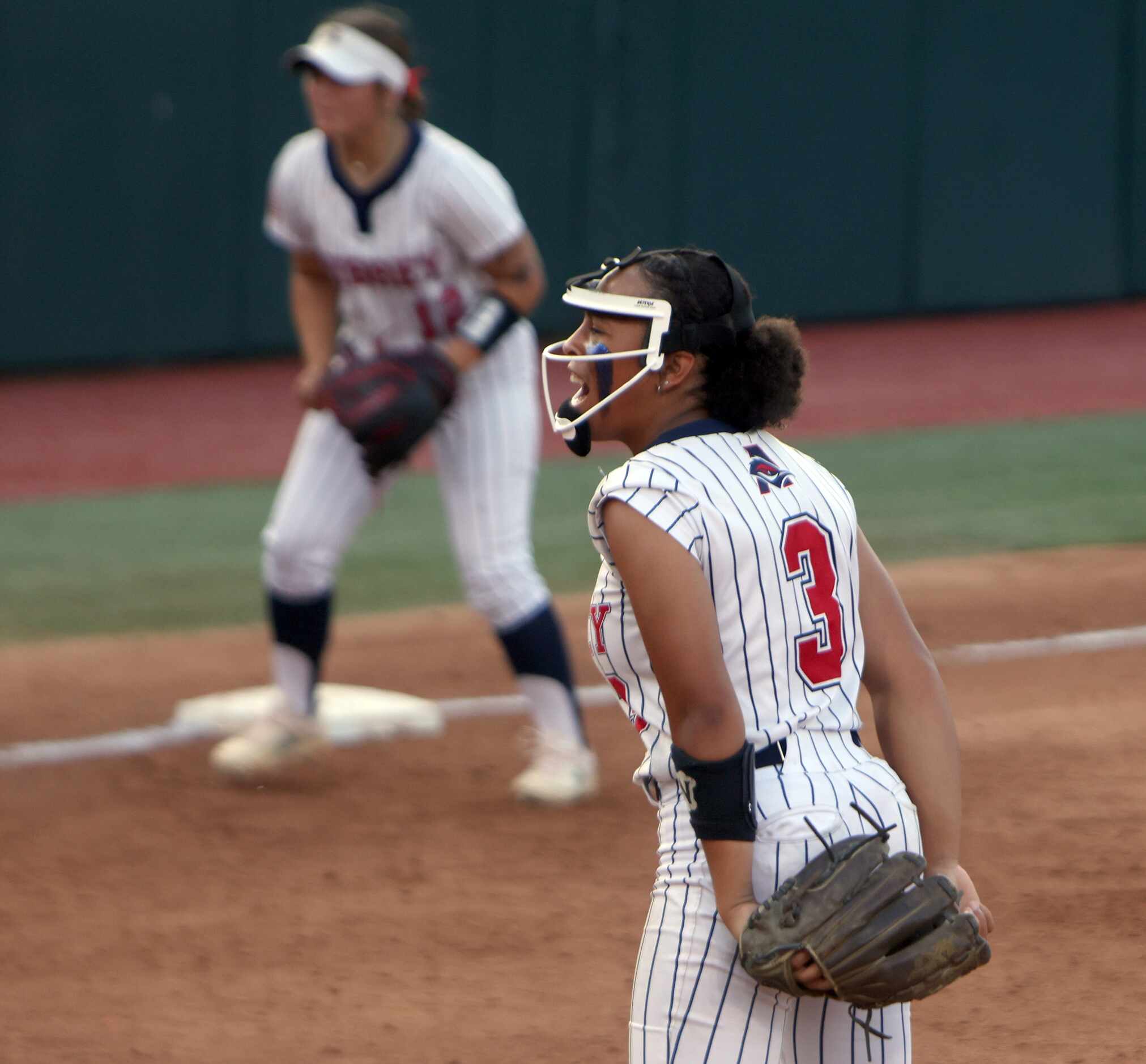 Aubrey pitcher Mya Cherry (3) lets out a yell after striking out the final Corpus Christi...