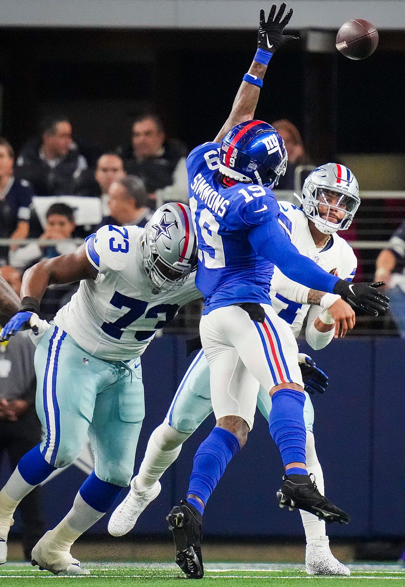 Dallas Cowboys quarterback Dak Prescott (4) throws a pass under pressure from New York...