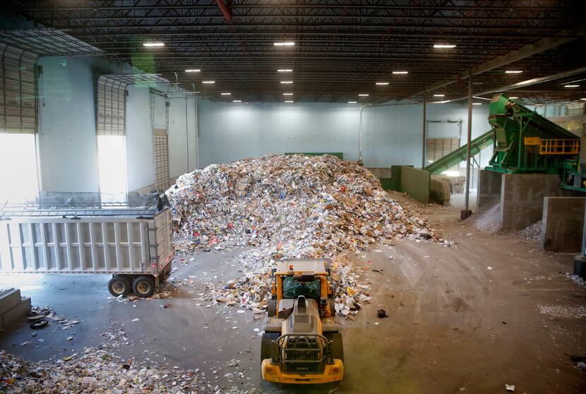 Recyclable material is piled on the tipping floor ready to be sorted at the Dallas recycling...