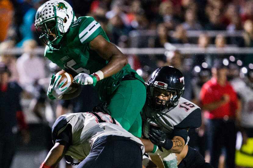 Southlake Carroll running back Audricke Gaines (15) is tackled by Euless Trinity defensive...