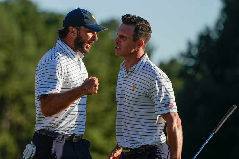 Max Homa celebrates with Billy Horschel after winning the 18th hole during their fourball...