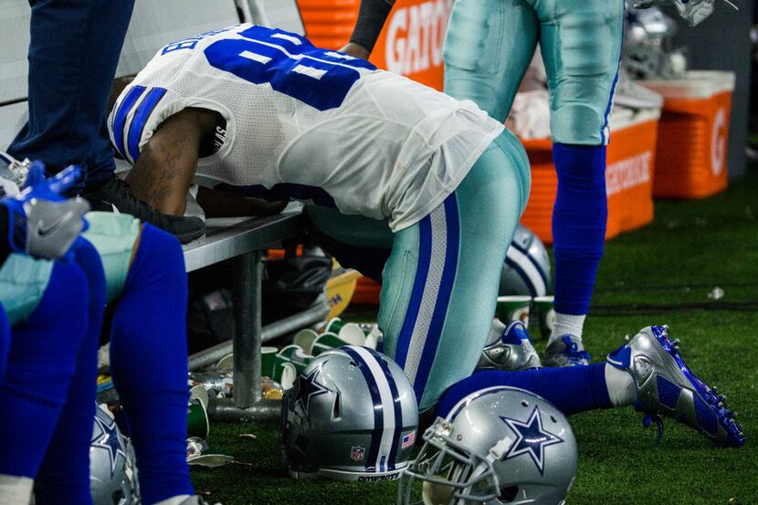 Dallas Cowboys wide receiver Dez Bryant (88) kneels down on the bench in the final moments...