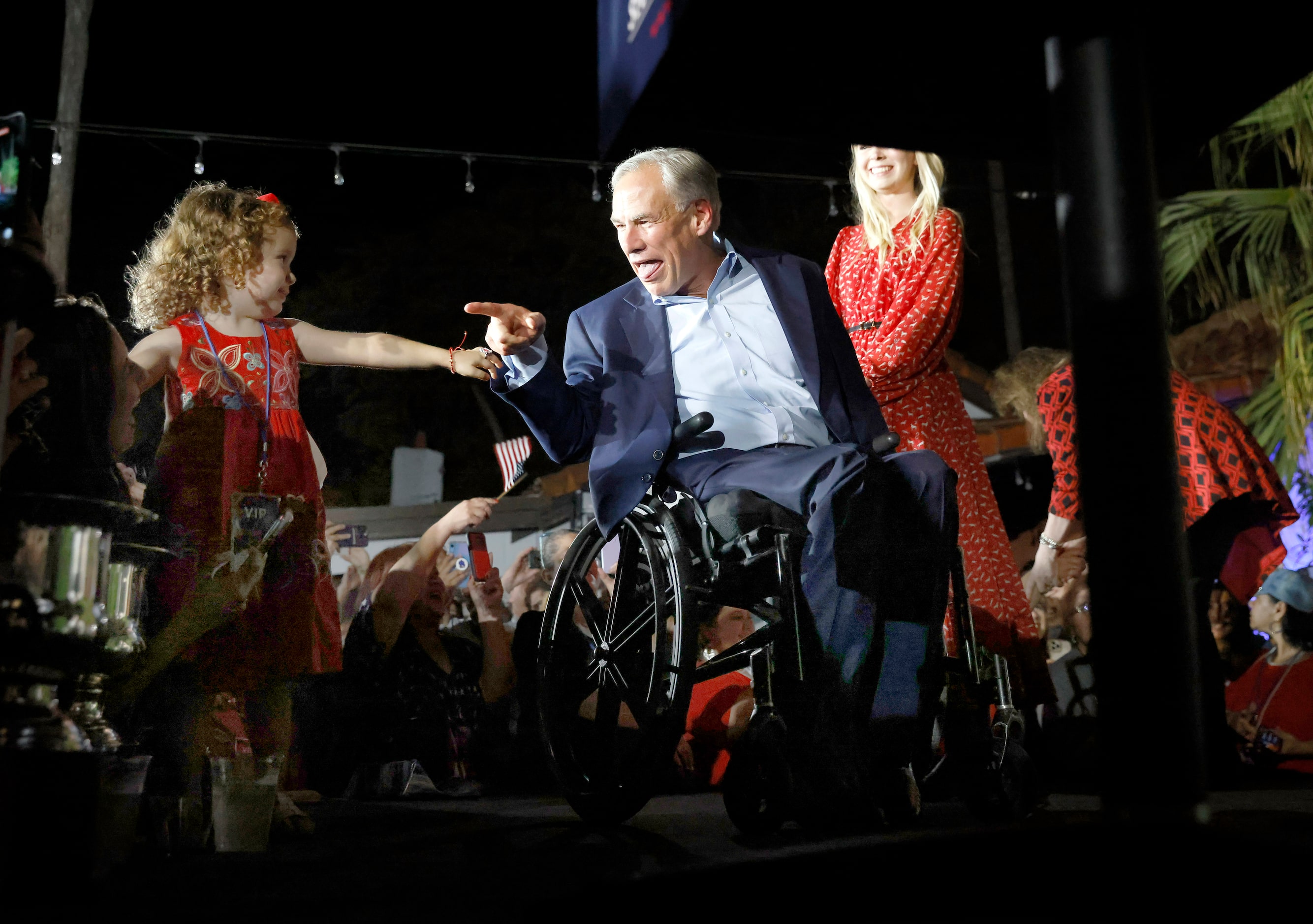 Texas Governor Greg Abbott points to young supporter in the front row as he arrives to make...