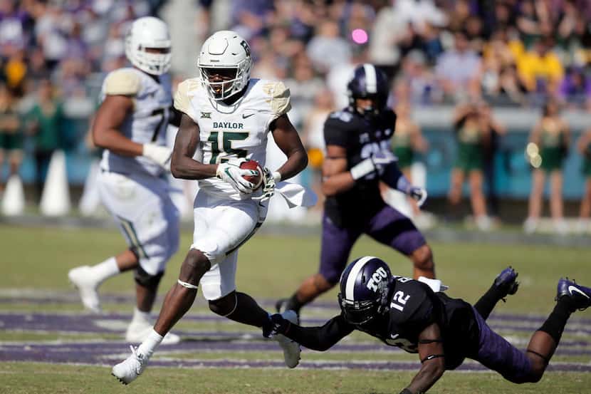FILE - IN this Nov. 24, 2017, file photo, Baylor wide receiver Denzel Mims (15) gets past...