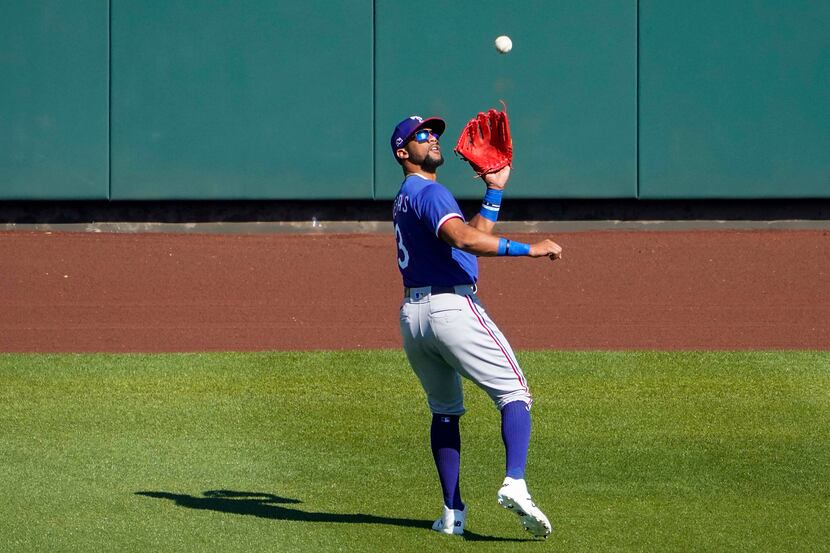 Texas Rangers center fielder Leody Taveras makes a catch on a fly ball by Arizona...