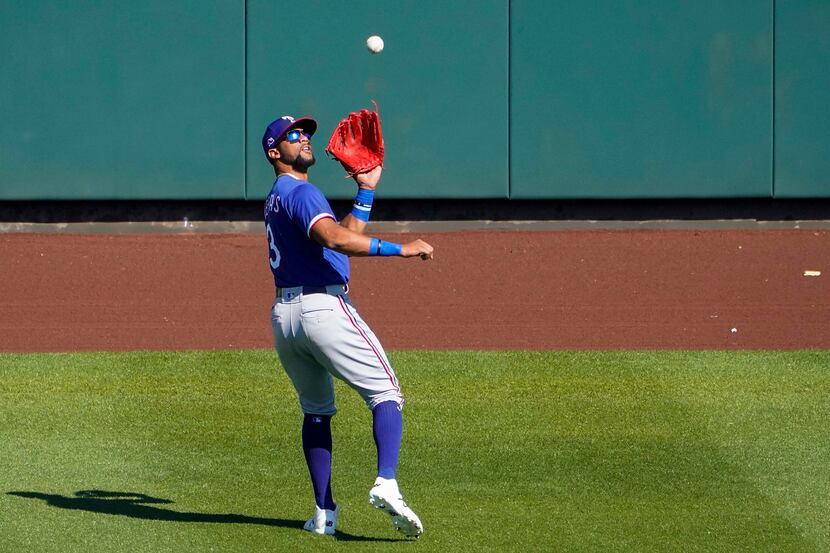 Texas Rangers center fielder Leody Taveras makes a catch on a fly ball by Arizona...