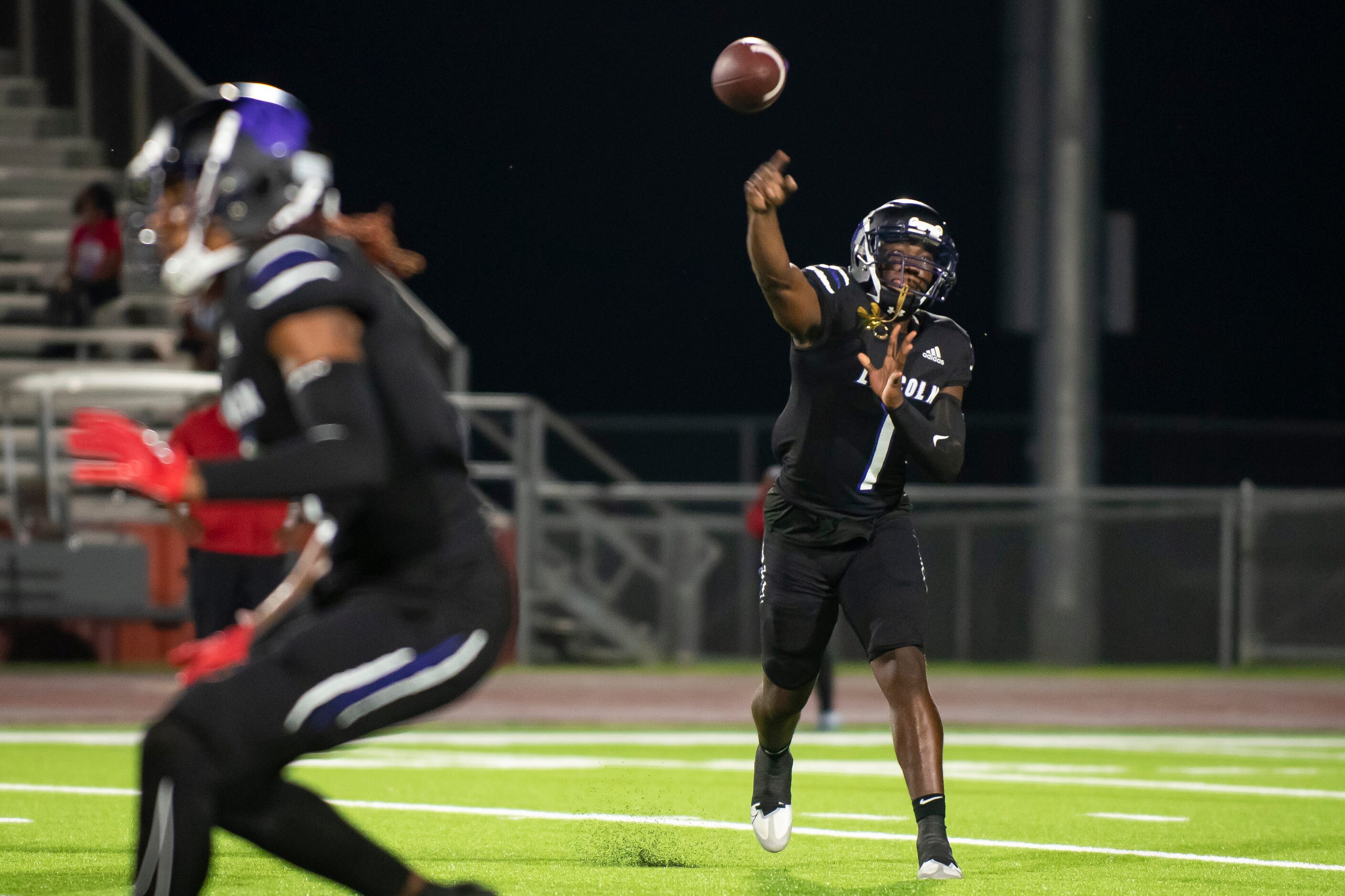 Lincoln senior Jaden Cole (1) passes the ball to a teammate during a high school football...