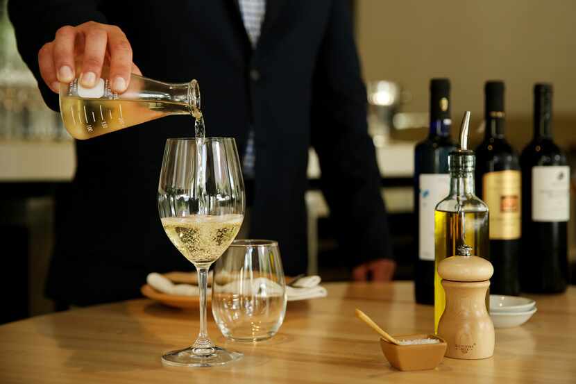 Richard Patino, general manager and wine director of Sachet restaurant, pours a Moschofilero...