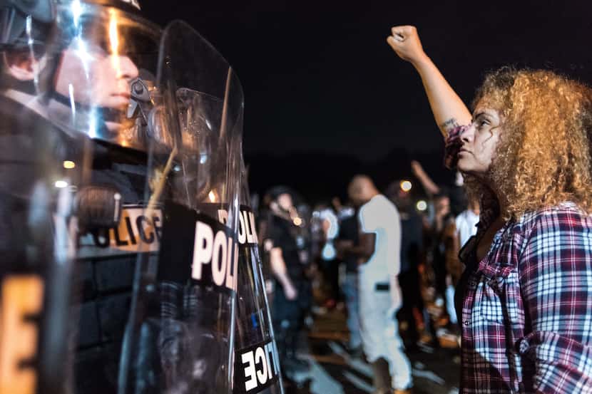 Police officers face off with protestors  on I-85 during protests following the fatal...