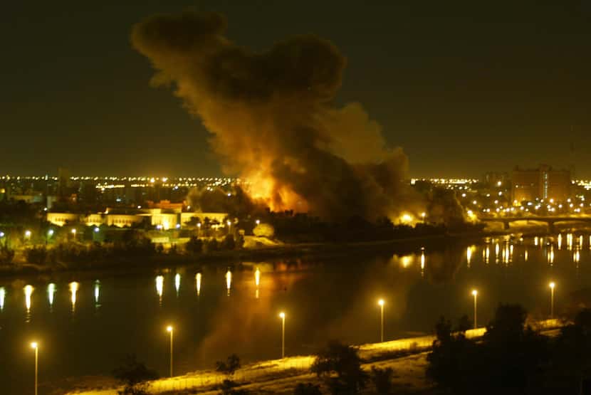 File picture dated March 20, 2003 shows smoke billowing after a missile hit the planning...