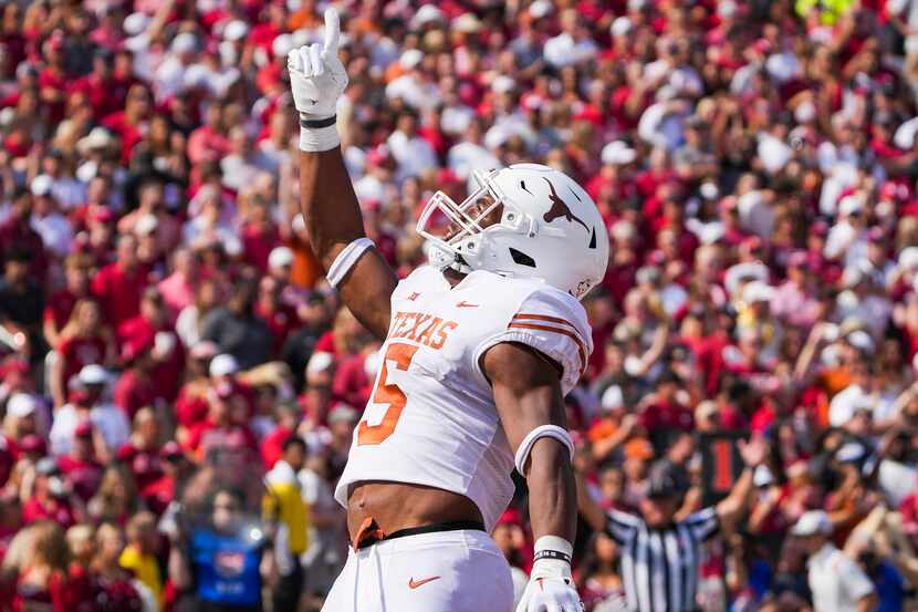 Texas running back Bijan Robinson (5) celebrates after scoring on a touchdown run during the...