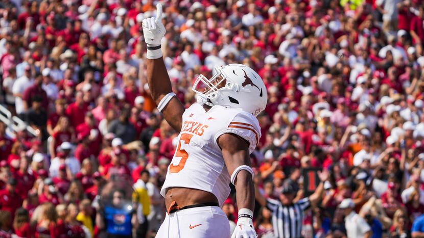 Texas running back Bijan Robinson (5) celebrates after scoring on a touchdown run during the...