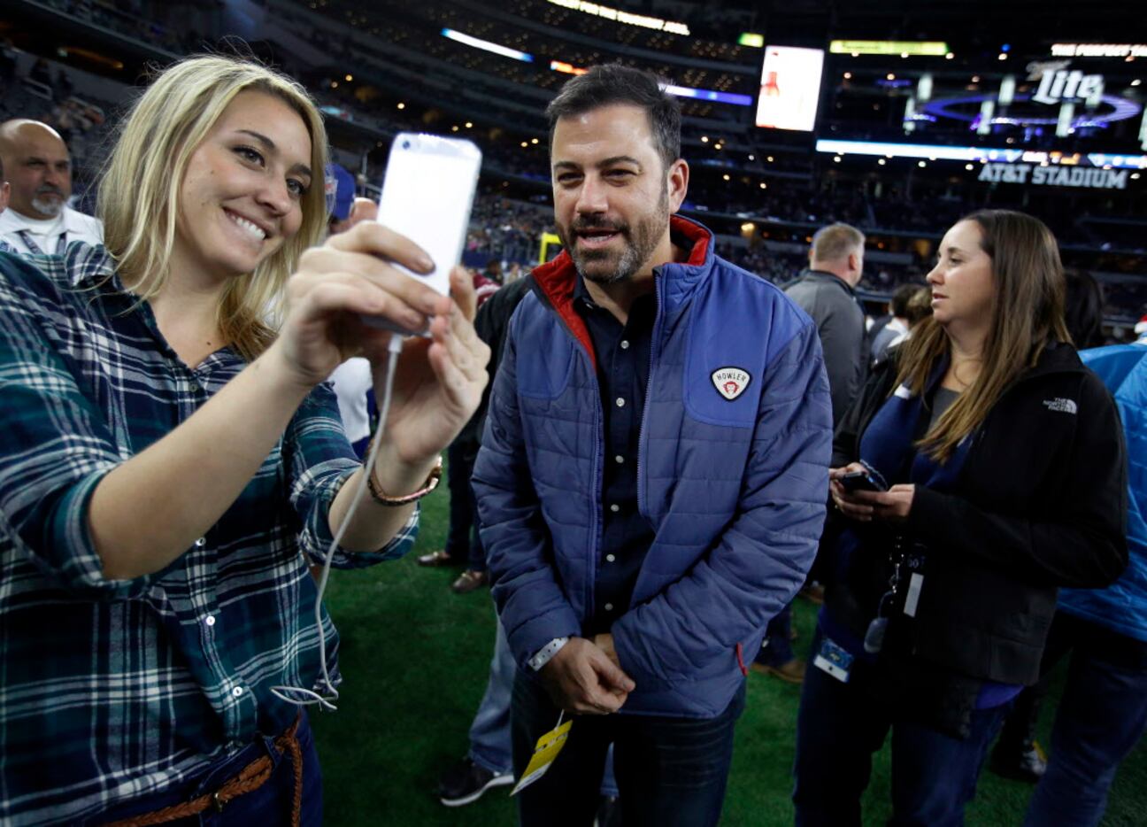 Talk show host Jimmy Kimmel (center) does a snap chat for the NFL Network with social media...