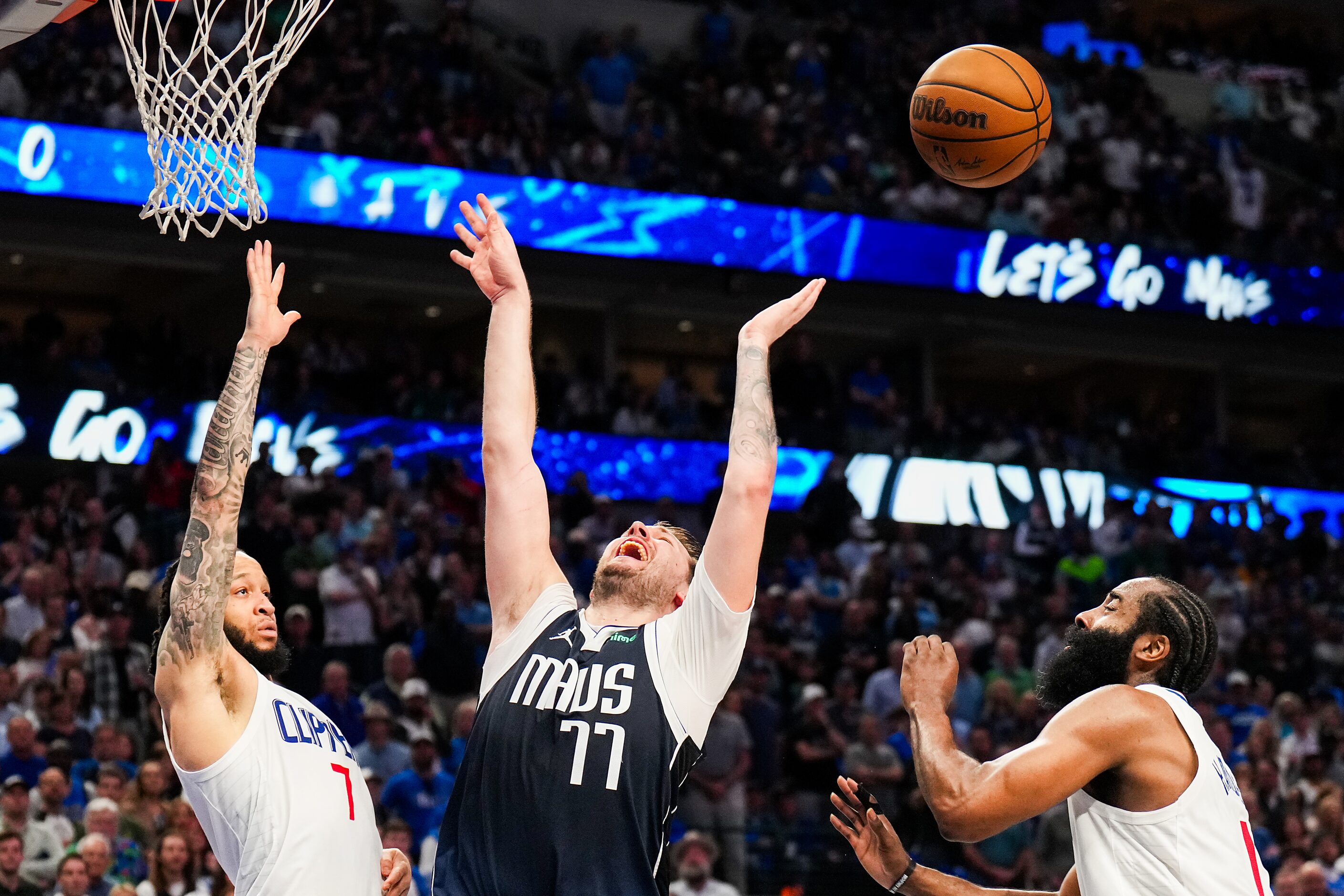 Dallas Mavericks guard Luka Doncic (77) loses the ball as he tries to drive between LA...