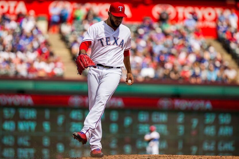 Texas Rangers starting pitcher Martin Perez kicks at the dirt after giving up a run during...