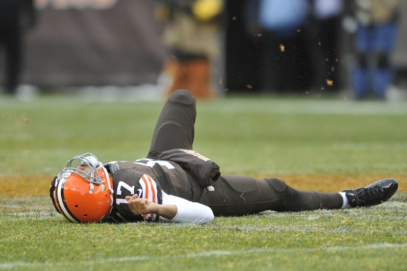 Cleveland Browns quarterback Jason Campbell lies near midfield after suffering a concussion...