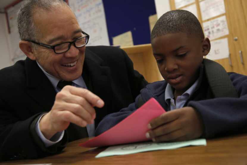 Mike Miles talked with Aexezavion Webb, 9, about classwork during a surprise visit to Lee A....