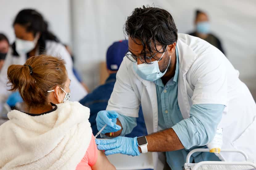 Pharmacy manager Sam Patel administers a COVID-19 vaccine at a vaccination clinic at the...