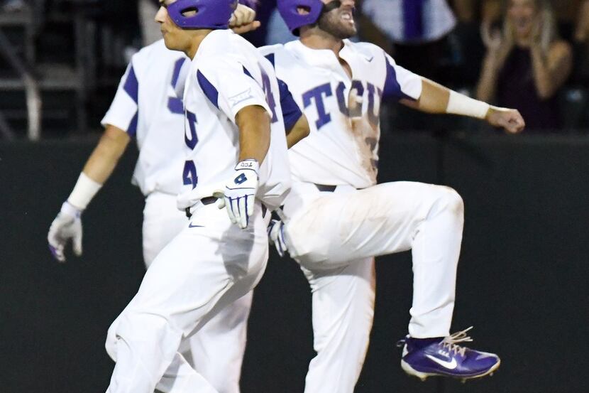 TCU 's Johnny Rizer, left, and A.J. Balta celebrate as they cross home plate for a 3-0 lead...