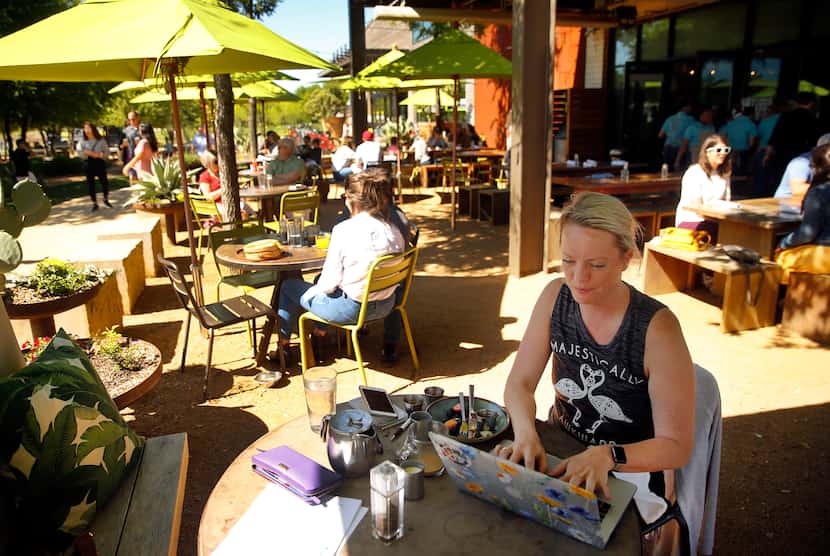 Working on her laptop, Stevi Motheral of Fort Worth has brunch on the Press Cafe patio at...