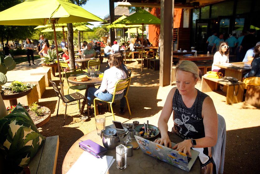 Working on her laptop, Stevi Motheral of Fort Worth has brunch on the Press Cafe patio at...