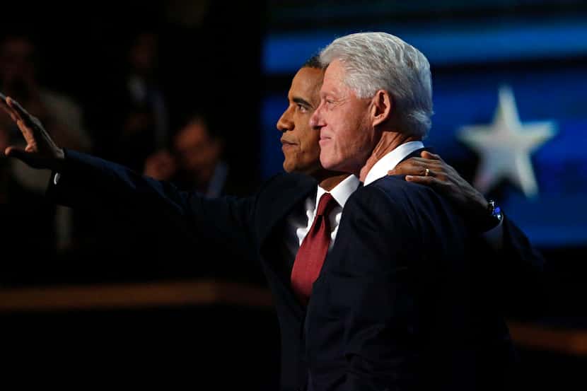 Former President Bill Clinton (right) and President Barack Obama embrace at the close of...