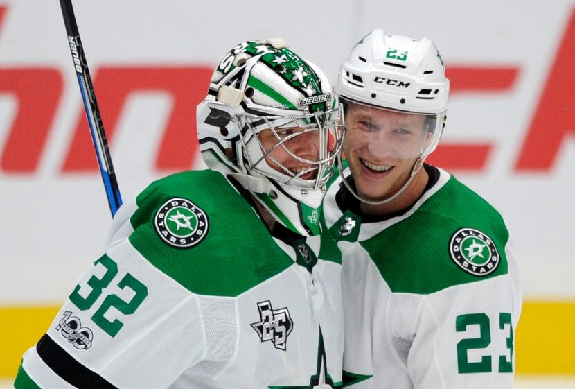 Dallas Stars goalie Kari Lehtonen (32), of Finland, celebrates with Esa Lindell (23), of...