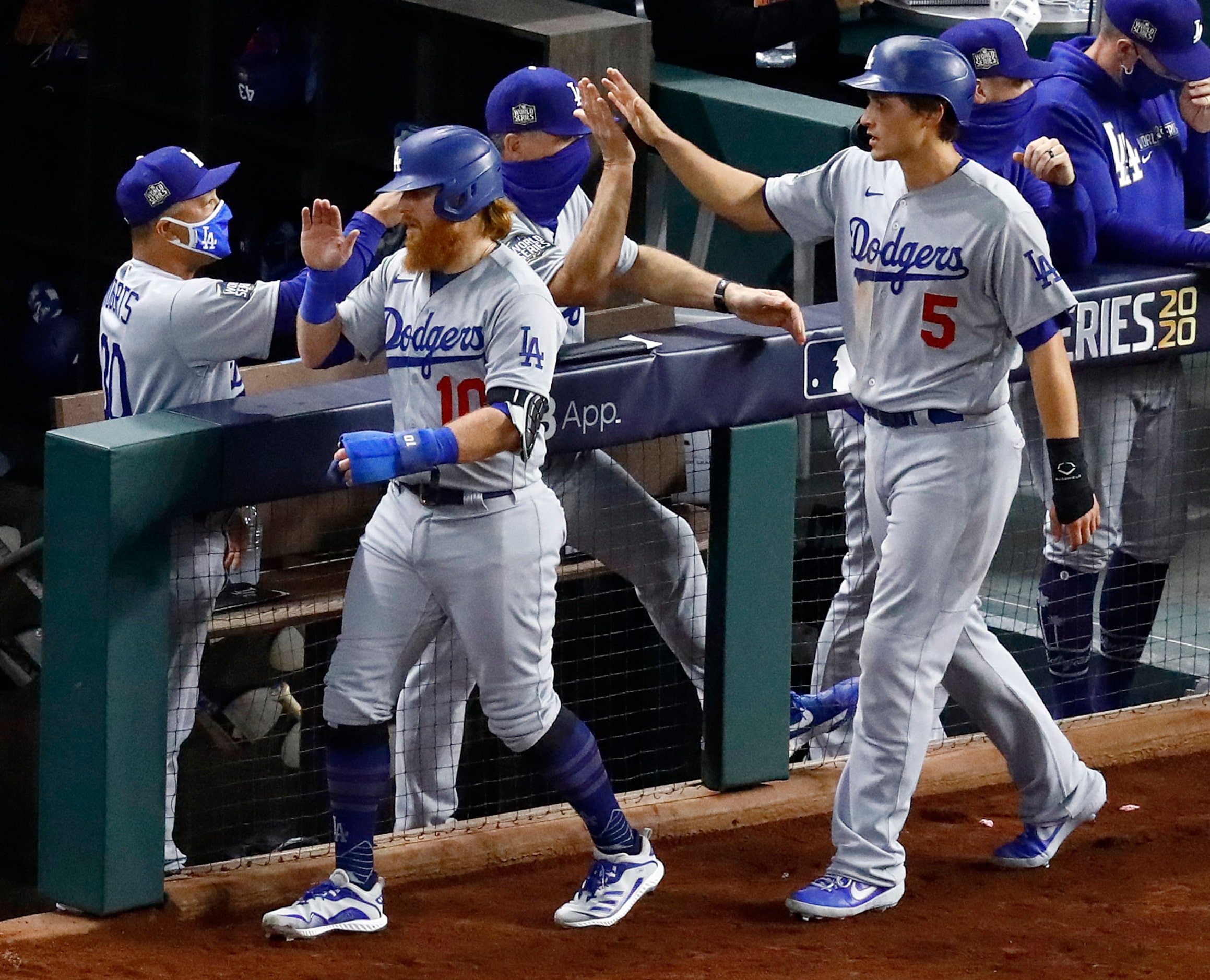 Los Angeles Dodgers shortstop Corey Seager and Justin Turner are congratulated on their...