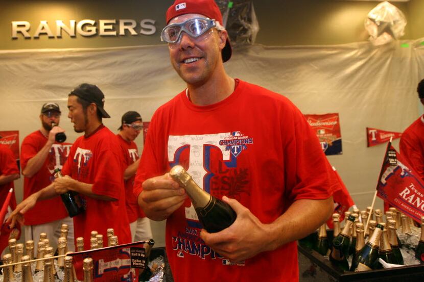 Texas Rangers left fielder David Murphy (7) enjoys the antics of teammates in the locker...