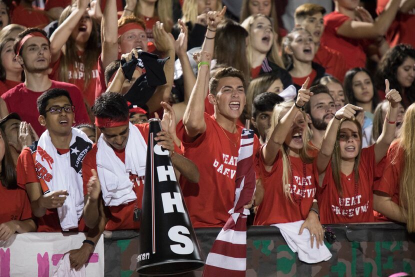 Heritage fans cheer after a turnover on downs during Grapevine's matchup against Colleyville...