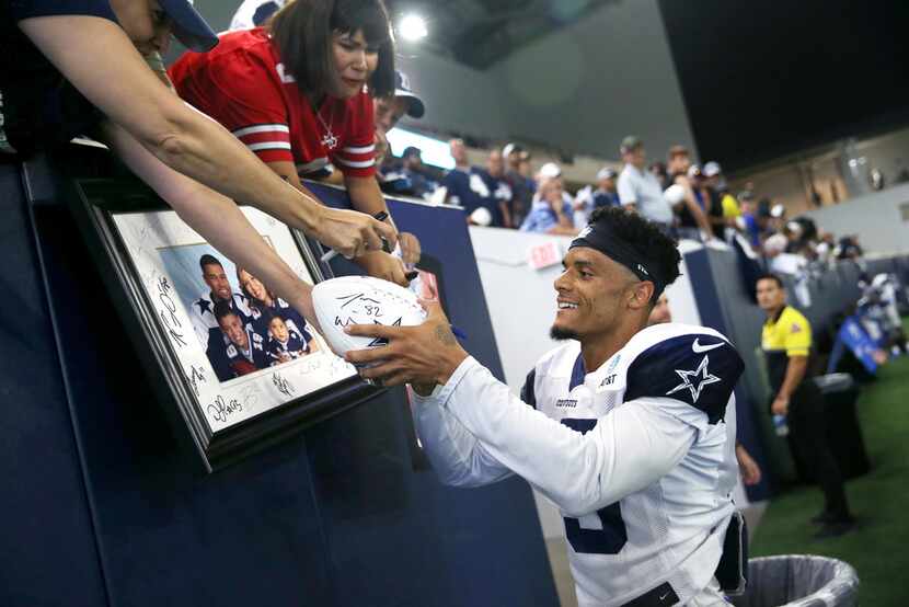 Dallas Cowboys wide receiver Devin Smith (15) signs autographs for fans during Dallas...