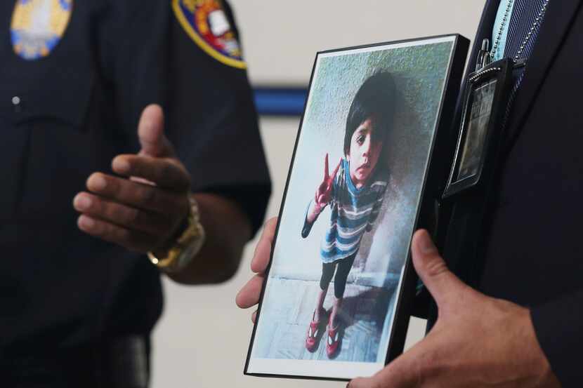 Galveston Police Detective Jeff Banks holds a photo of Jayden Alexander Lopez, the...